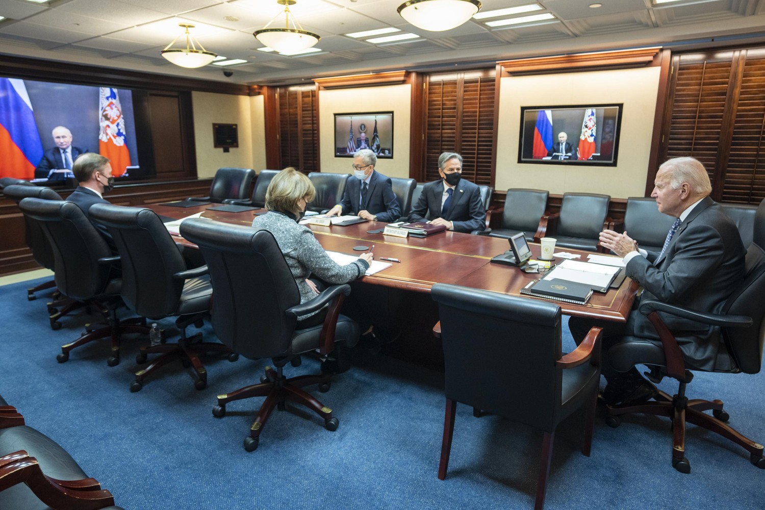 In this image provided by The White House, President Joe Biden speaks as he meets virtually via a secure video conference with Russian President Vladimir Putin from the Situation Room at the White House in Washington, Tuesday, Dec. 7, 2021. At far left is White House national security adviser Jake Sullivan along with Secretary of State Antony Blinken, right, national security council senior director for Russian and Central Asia, Eric Green. (Adam Schultz/The White House via AP)