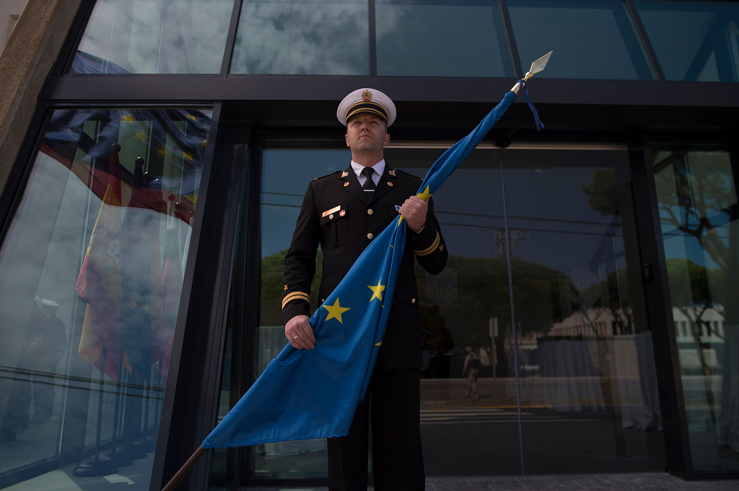 A soldier holds a European Union flag during a ceremony marking the relocation of the operation Headquarters of EU NAVFOR Atalanta Operation at the Rota Naval Base in Rota, on March 29, 2019. - The relocation of the Headquarters of the Operation has no precedent in the history of the EU and it includes the transfer to Brest of the Maritime Security Centre for the Horn of Africa, as part of the Operational Headquarters. On this occasion, the command has also been transferred from Major General Charlie Stickland, UK Royal Marines, to Vice Admiral Antonio Martorell Lacave, Spanish Navy. (Photo by JORGE GUERRERO / AFP) (Photo credit should read JORGE GUERRERO/AFP via Getty Images)